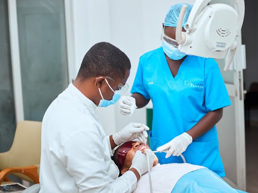 A dentist and assistant treating a patient